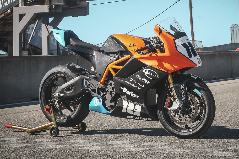 The V2-RS on track, in orange and black — where the VR workflow was first proven.